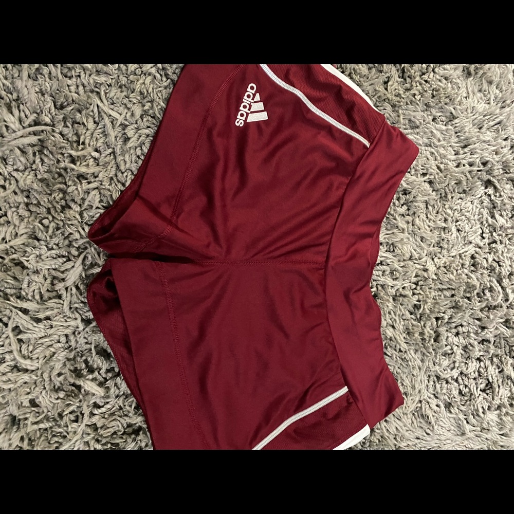 Adidas maroon with grey stripe shorts.